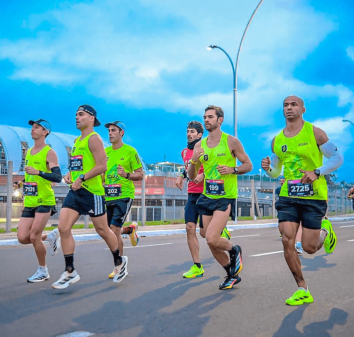 BORA athletes running side by side in their neon green jerseys